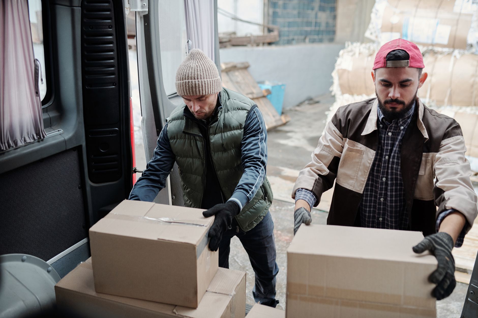cargo warehouse worker loading pet travel kennel onto airplane