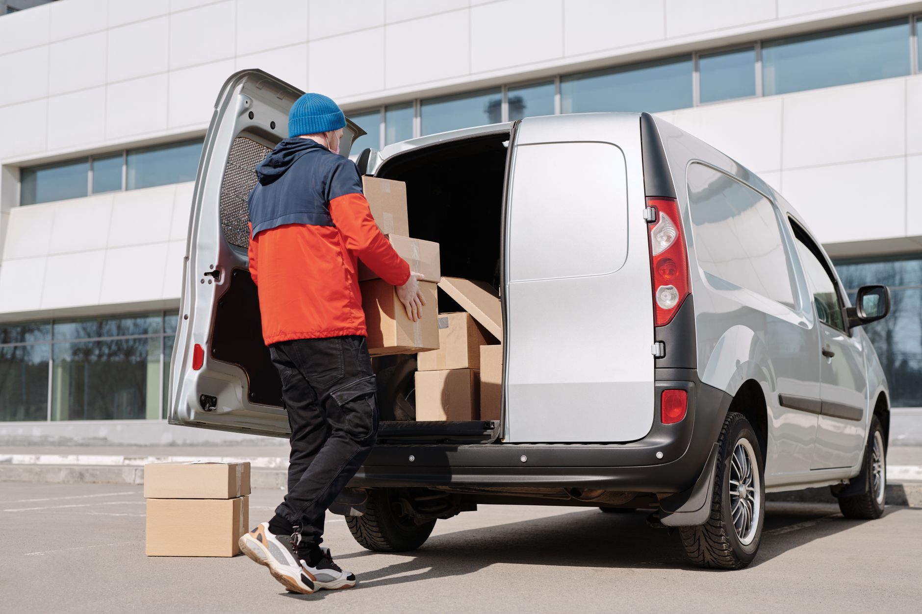pet transport van driver loading dog crate