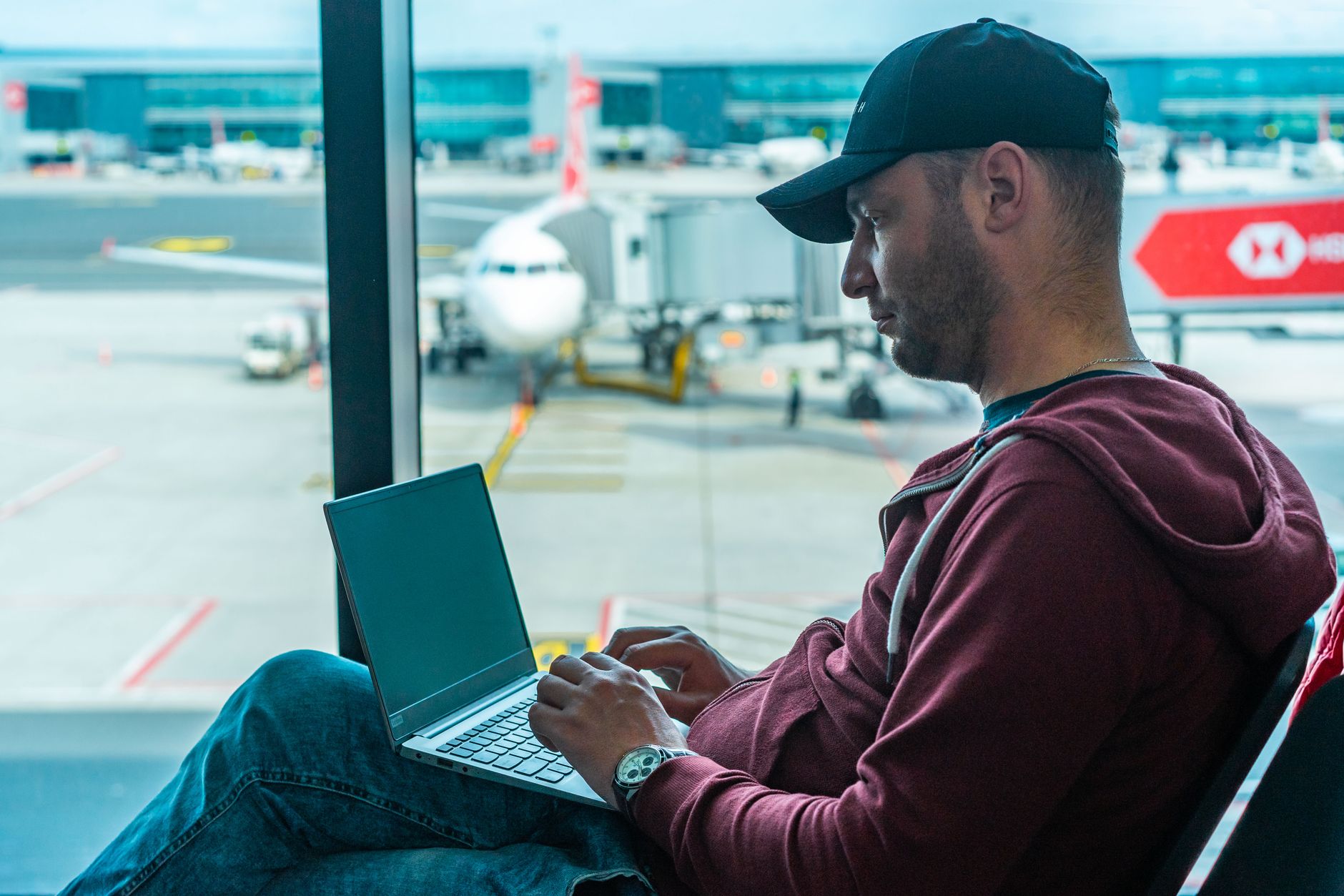 traveler using laptop checking government travel website at airport desk