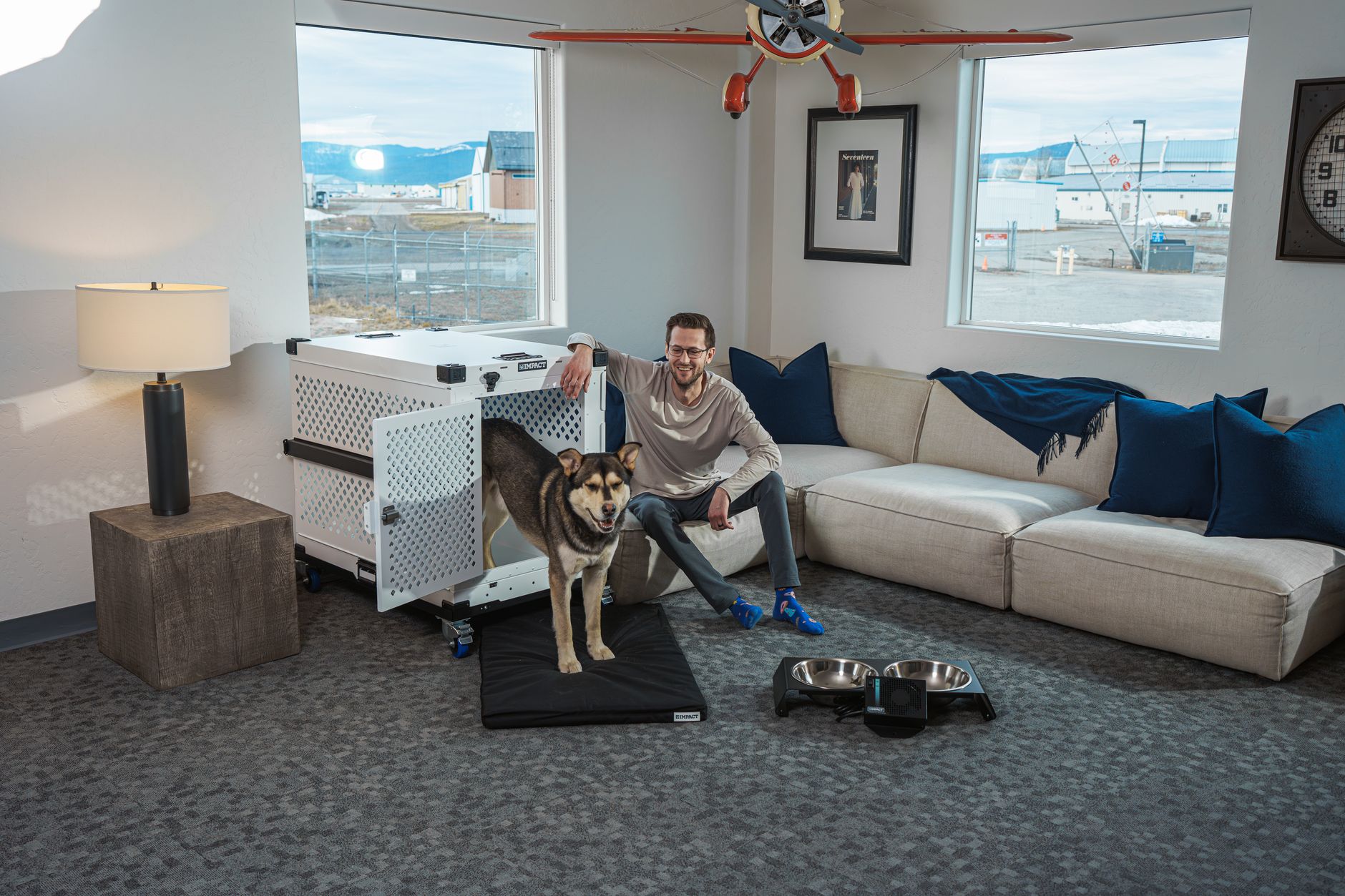 dog travel crate at airport check-in counter with owner