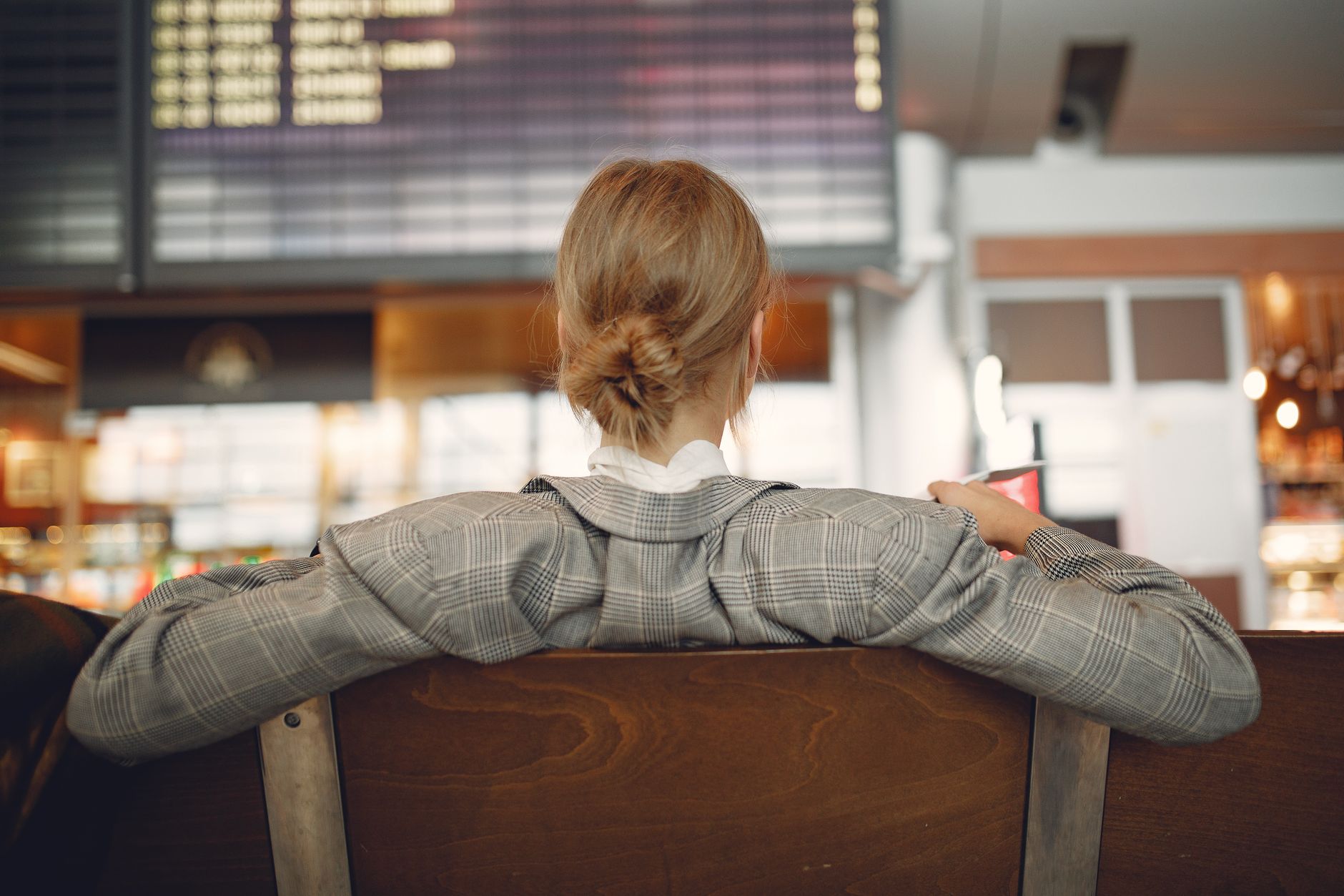 cat in ventilated under-seat pet carrier at airport departure gate