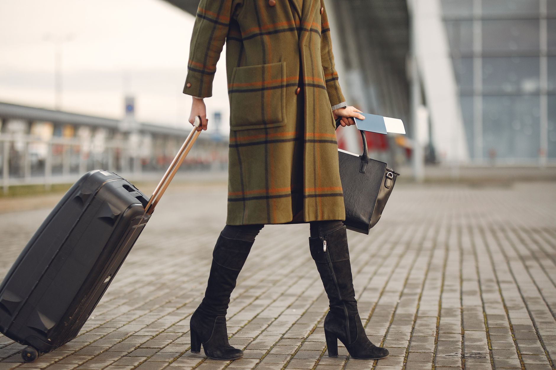 woman walking through airport terminal with cat carrier