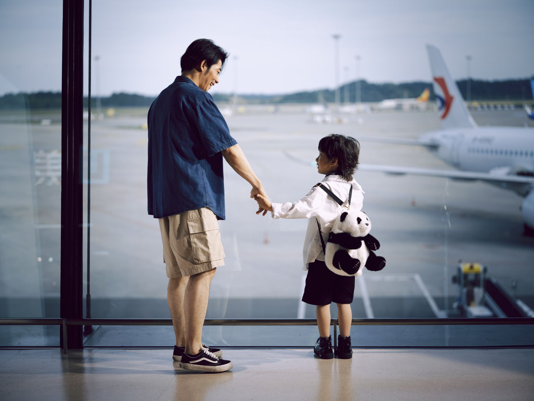 traveler holding cat at airport security checkpoint