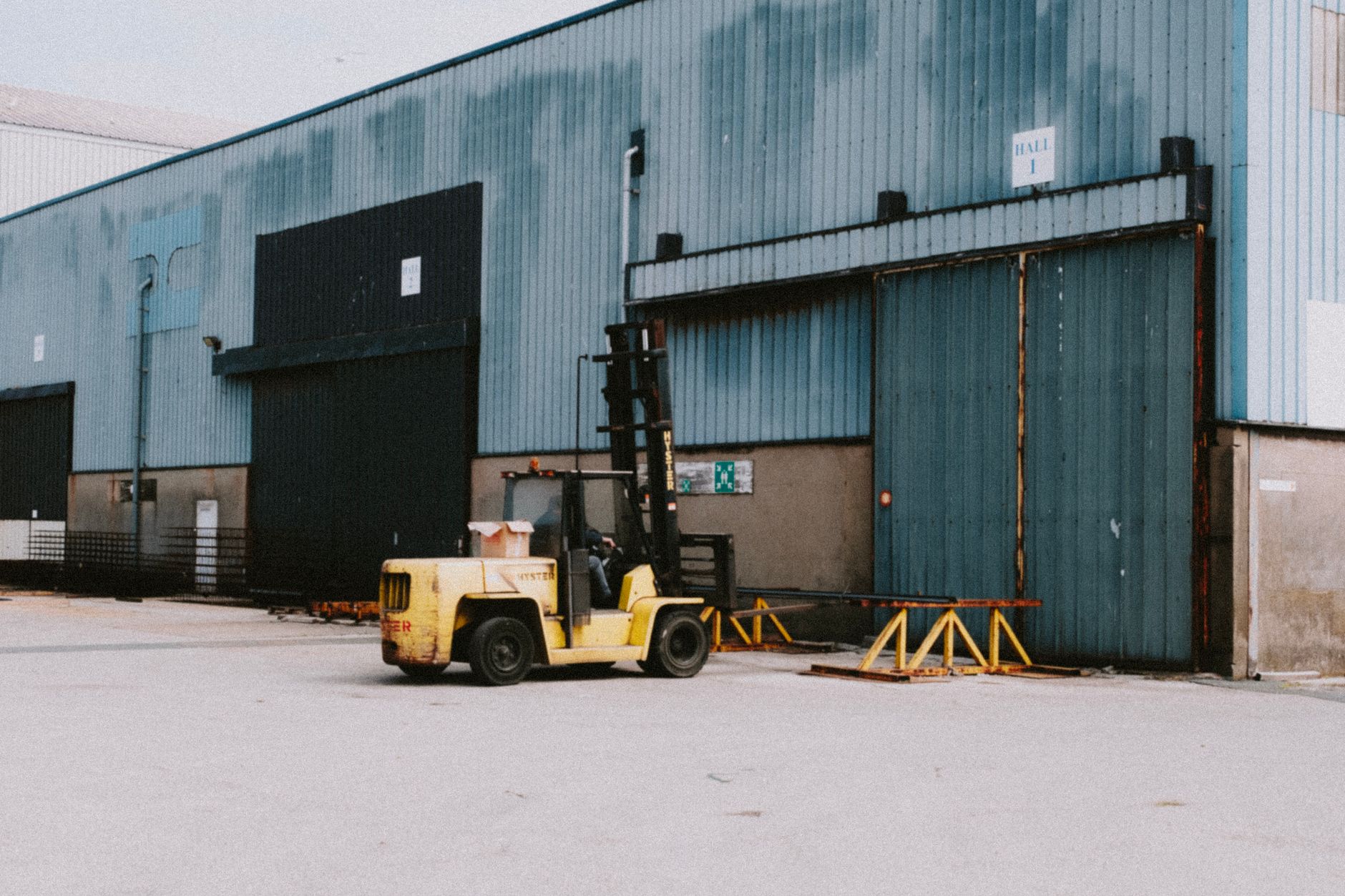 large dog in metal-door plastic travel crate at airport cargo warehouse