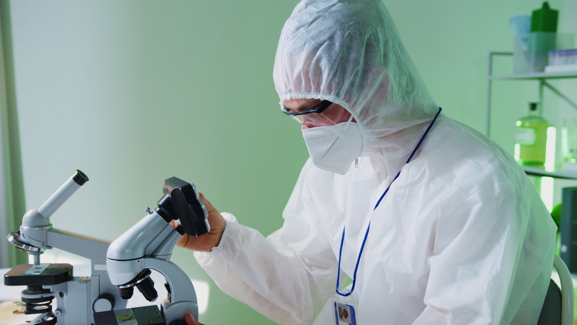 laboratory scientist reading fluorescent microscope rabies serology slide