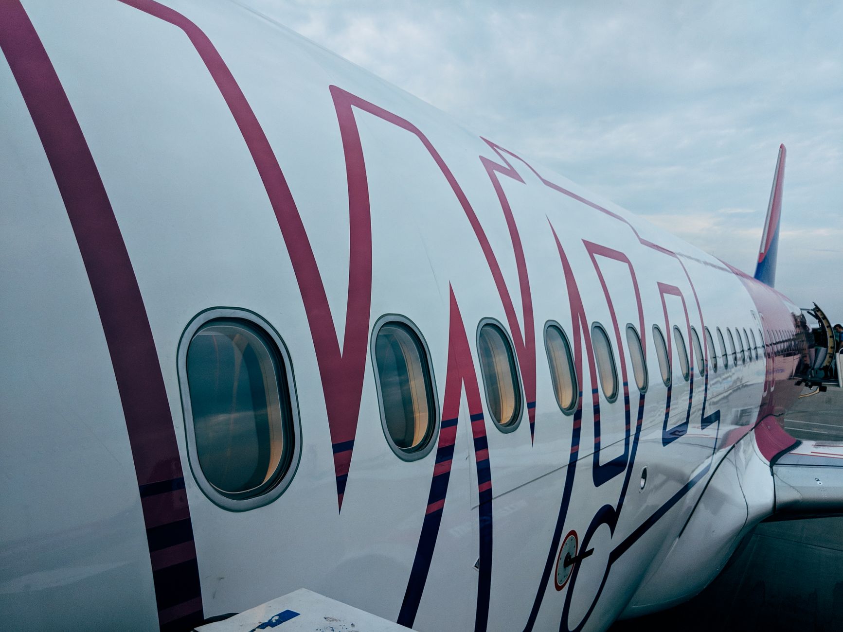 traveler boarding commercial jet with underseat pet backpack