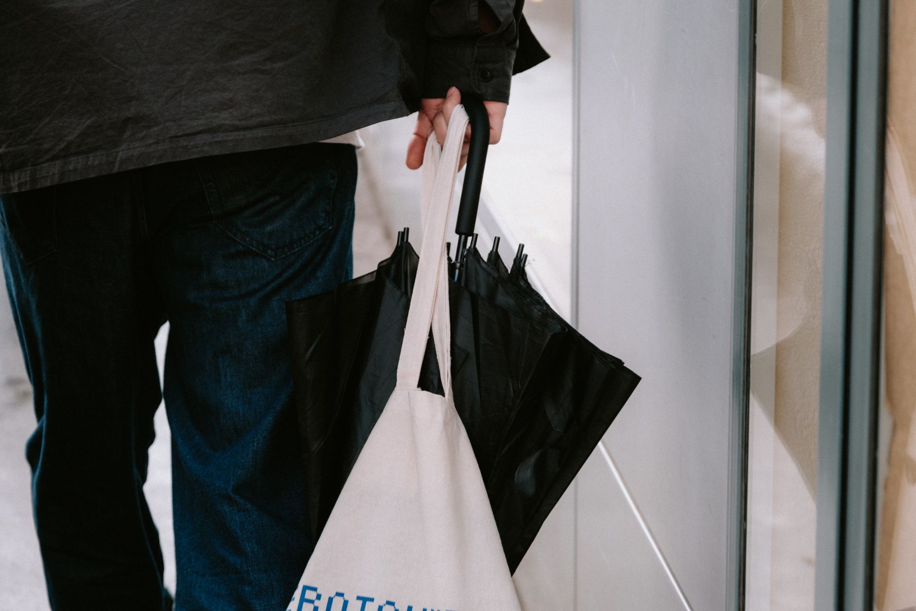 commuter carrying zippered dog tote bag through airport terminal hallway