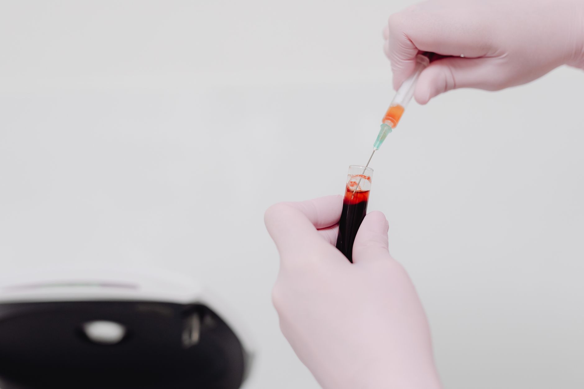 veterinarian drawing blood sample from dog for lab test