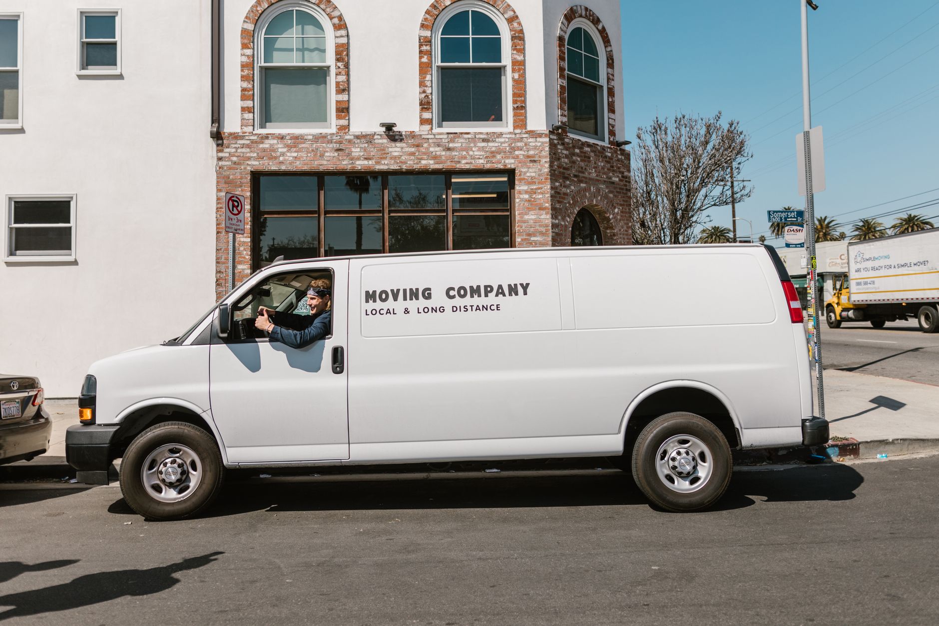 moving van loaded cross country with dog crate roadside stop
