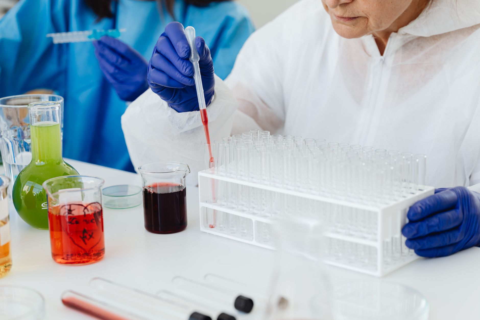 laboratory technician pipetting serum samples fluorescent test
