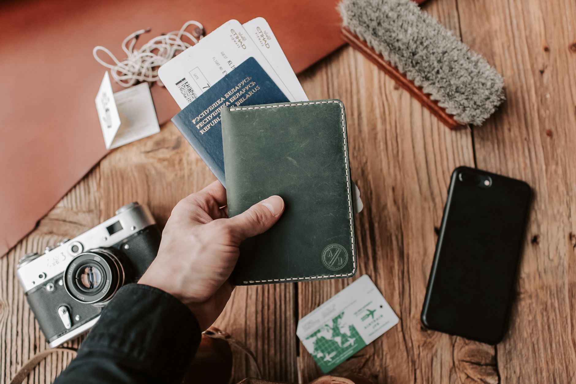small dog travel carrier next to passport and documents on table