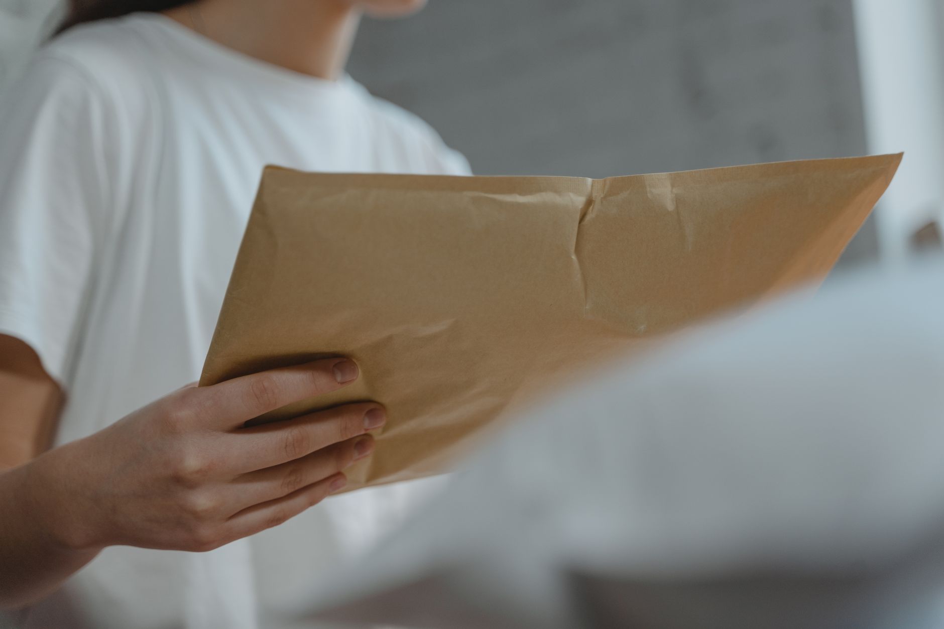 pet owner handing prepaid express envelope with veterinary papers at shipping counter