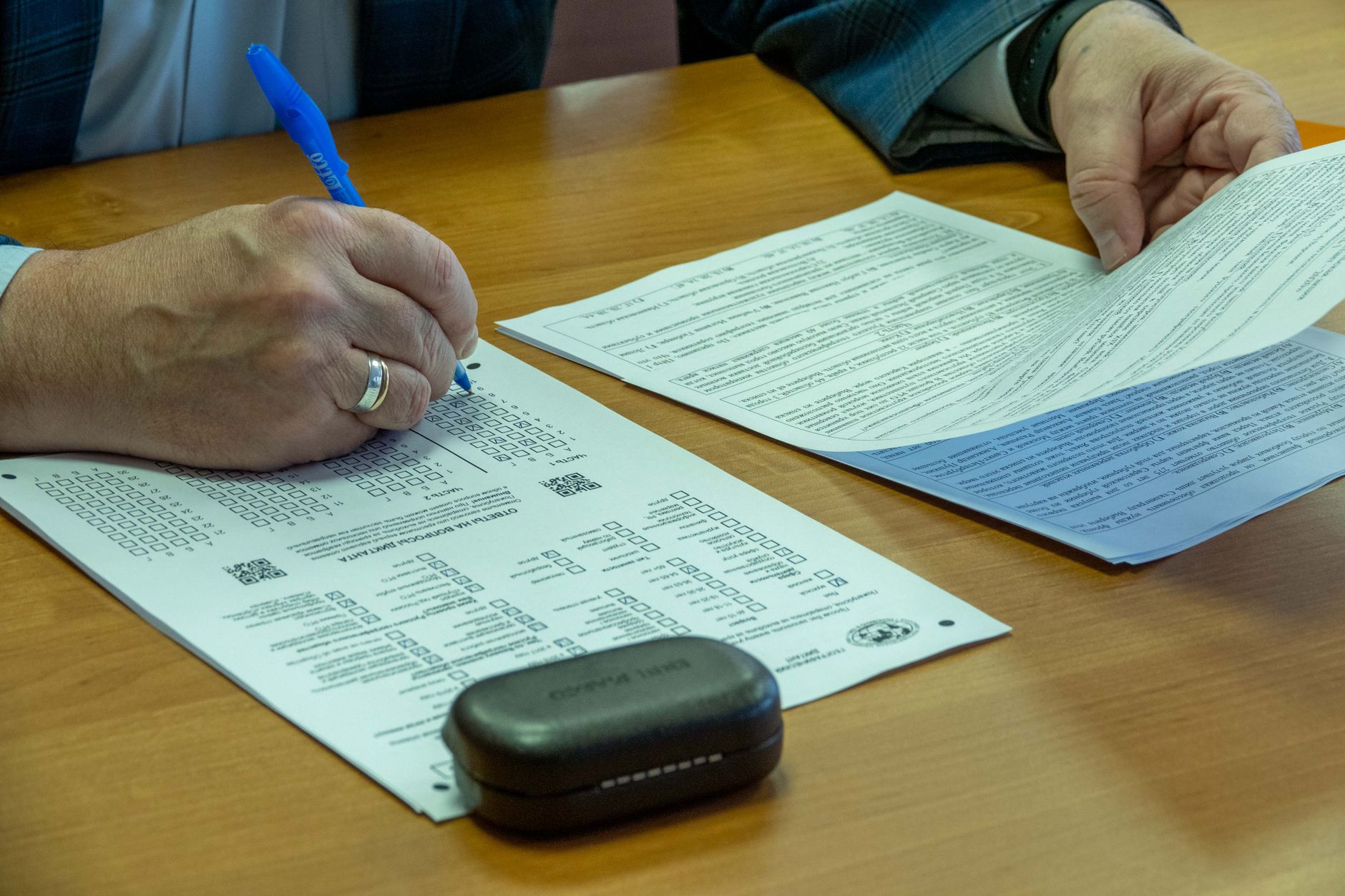 traveler with leashed dog completing airport paperwork desk