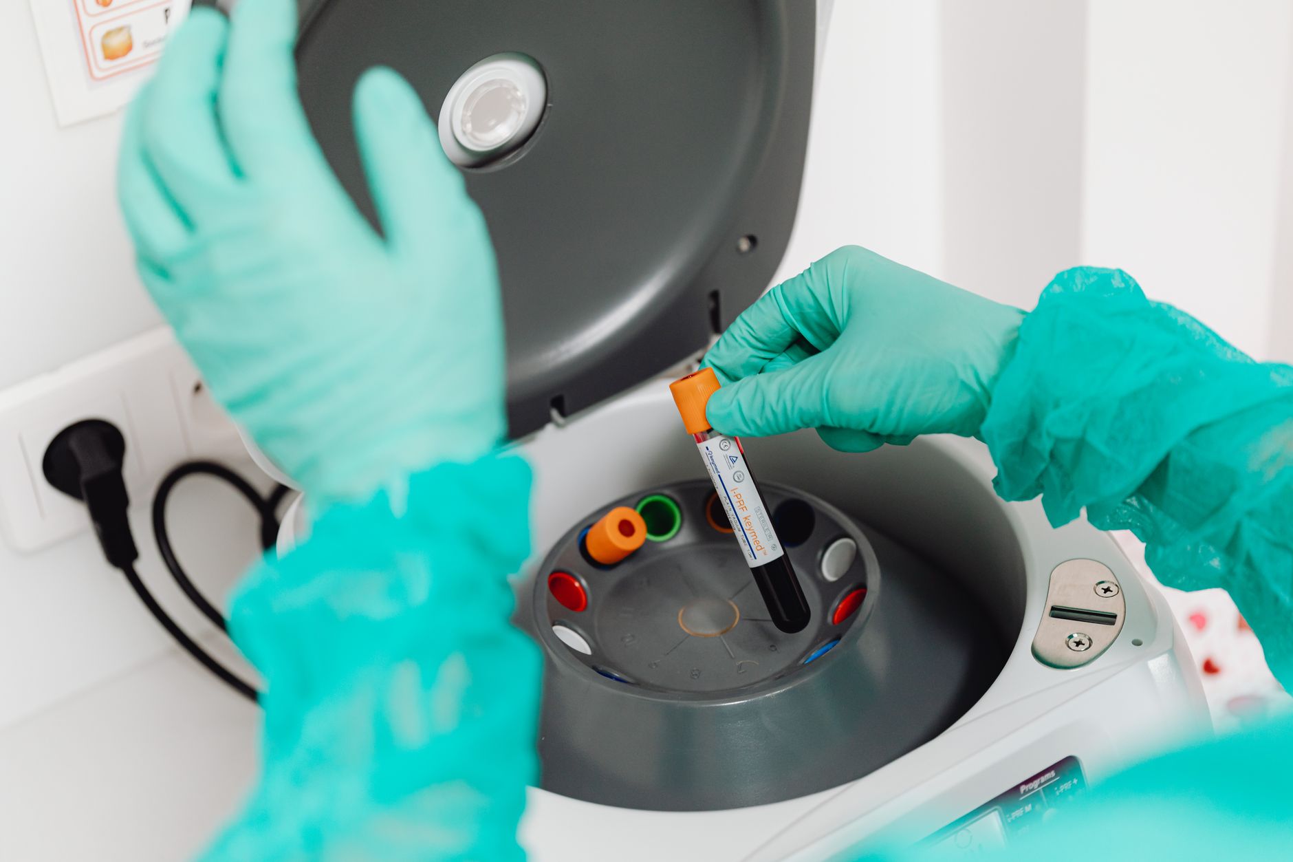 laboratory technician packing a chilled serum tube into an overnight courier box