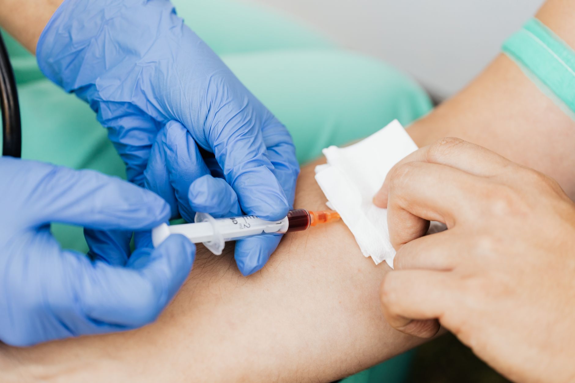 veterinarian drawing blood sample from dog for lab test clinic