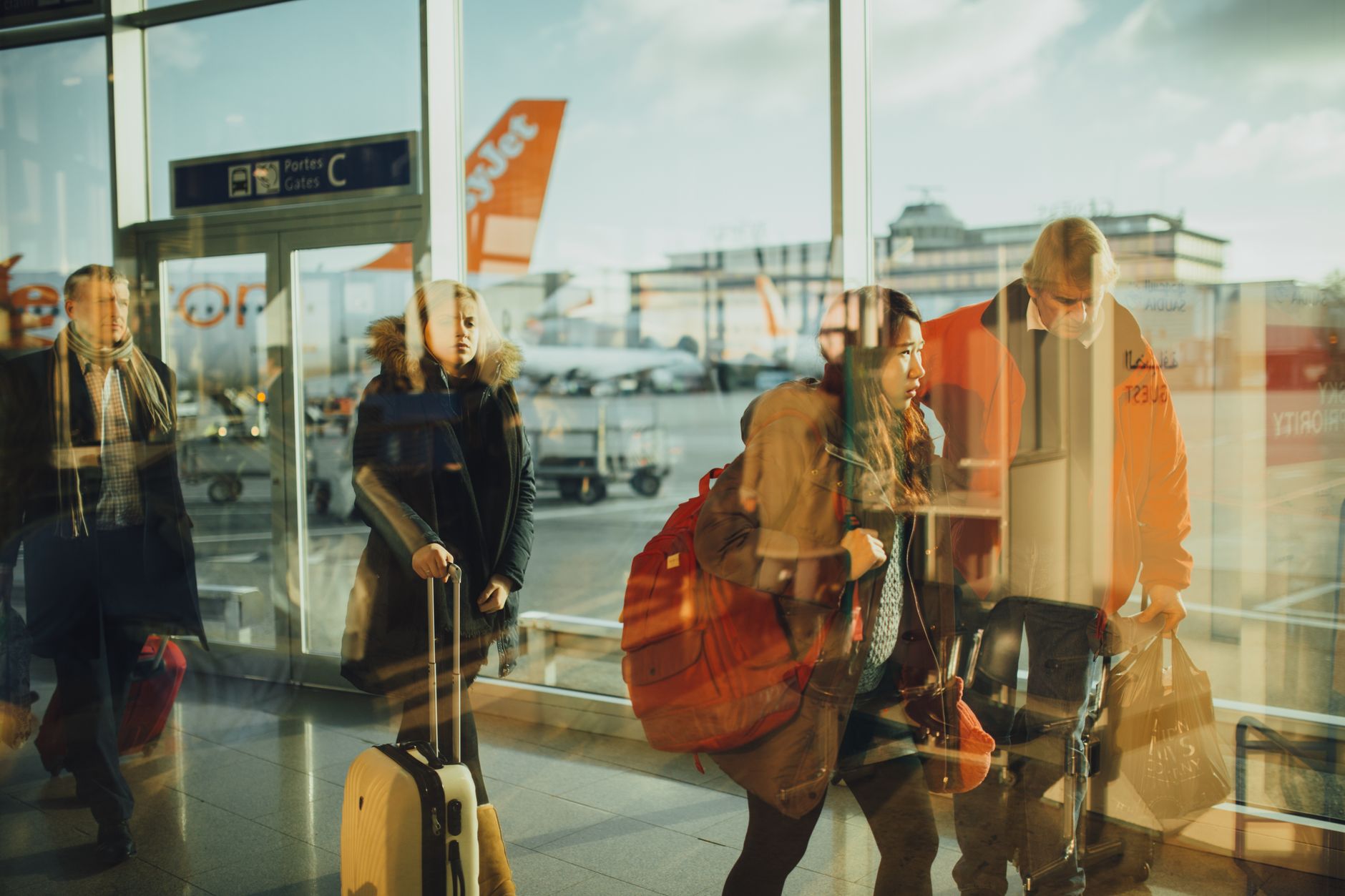 family with dog carrier airport departure gate Europe