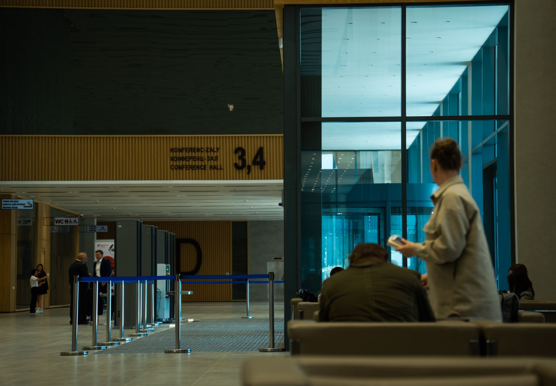 woman carrying cat through airport security checkpoint