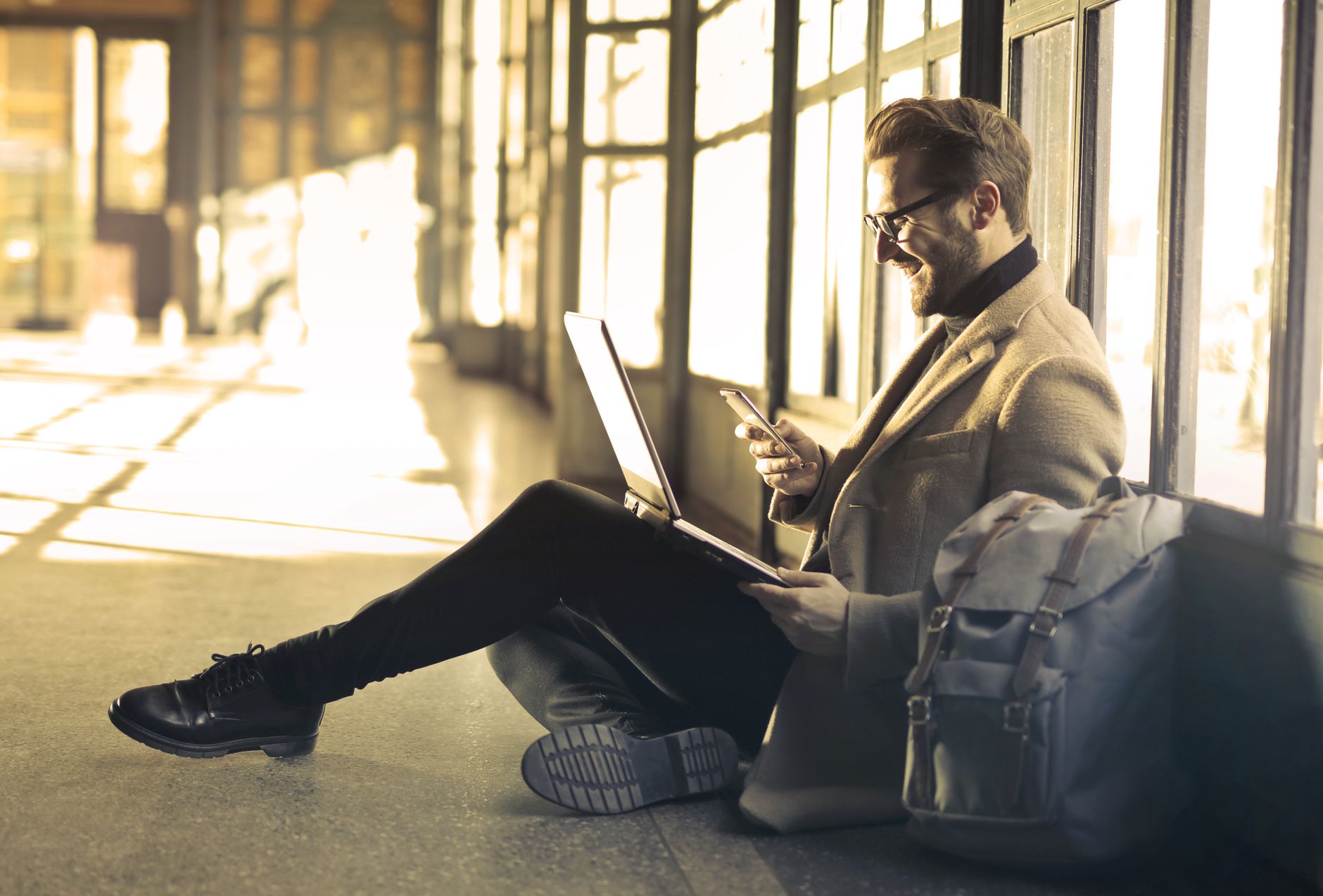 traveler using laptop checking government travel website at airport desk