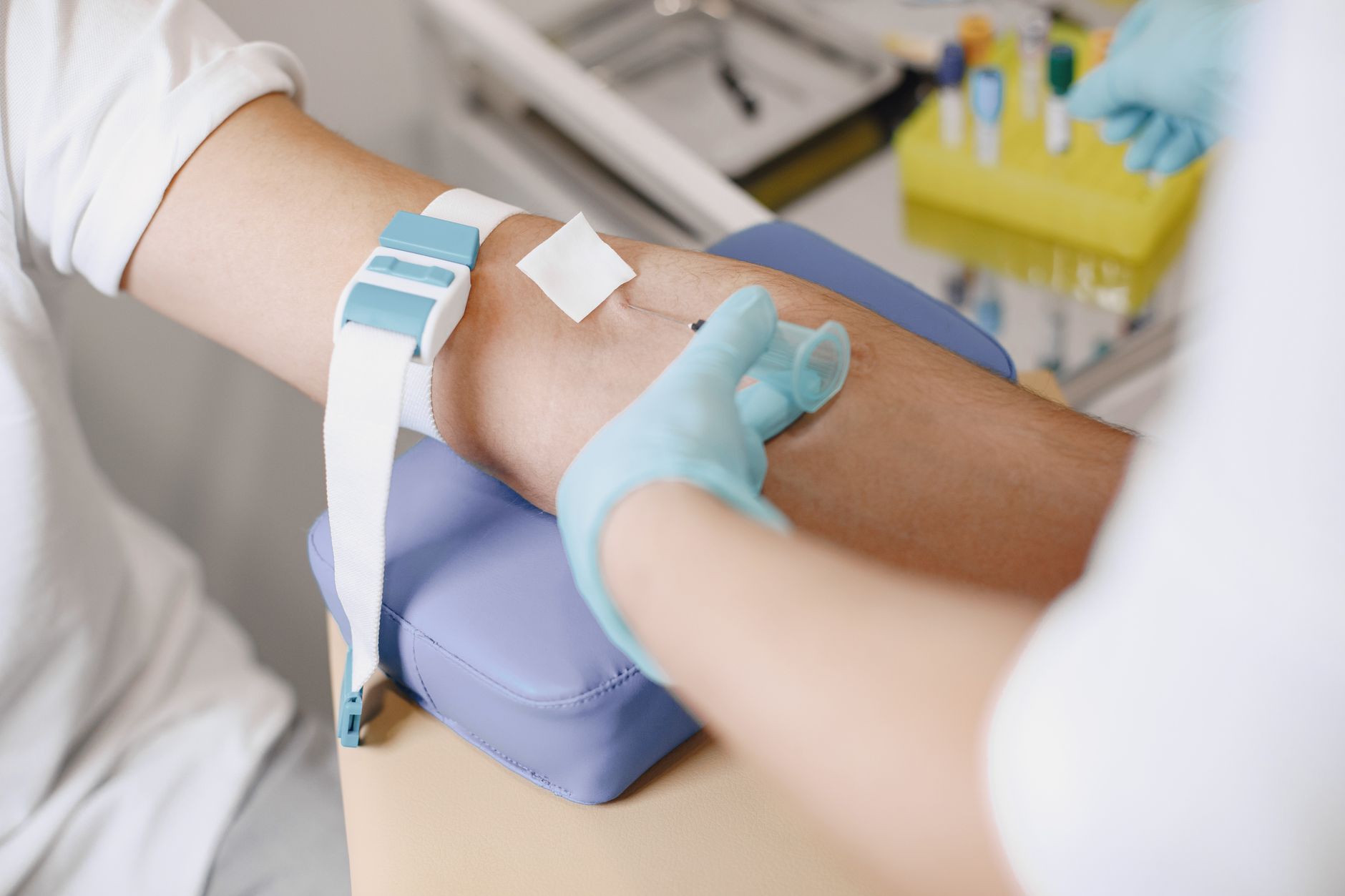 veterinarian drawing blood sample from dog clinic