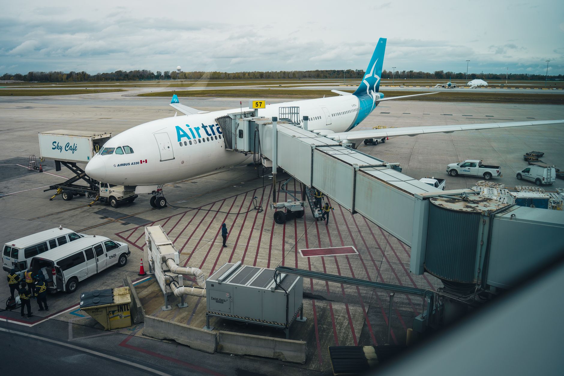 empty airport check-in counter with grounded yellow airplane outside window