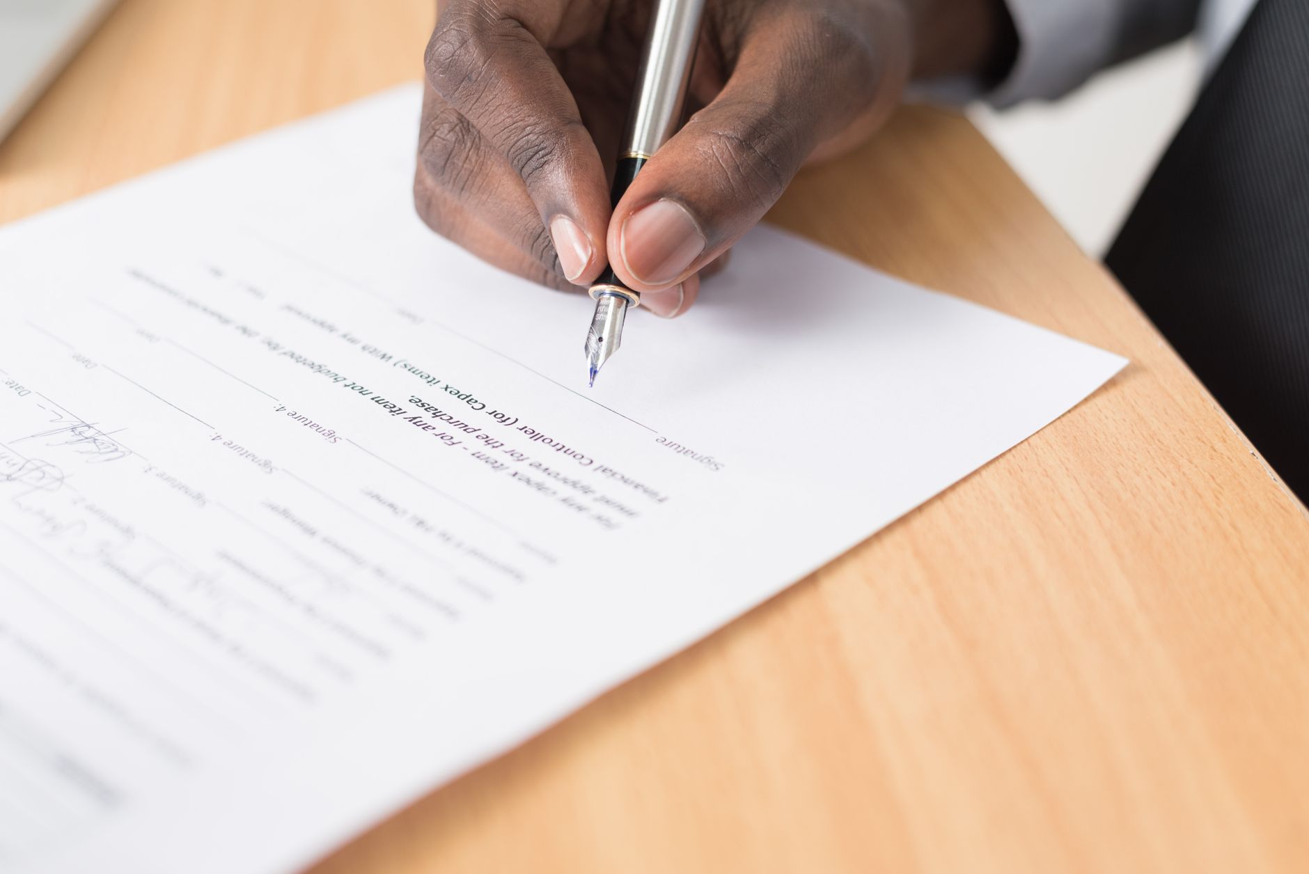 veterinarian completing pet health certificate paperwork at desk
